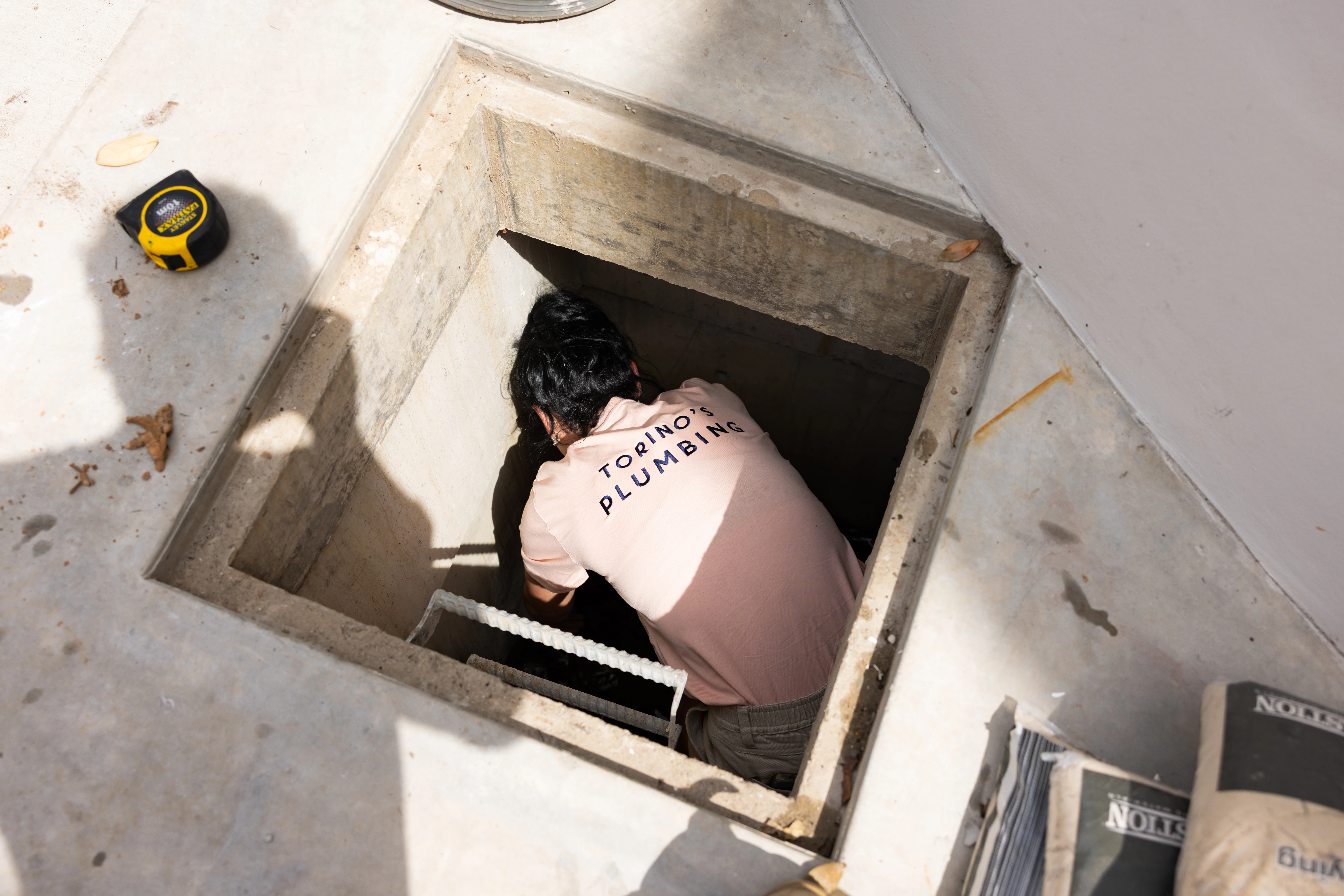 Plumber clearing a blocked drain