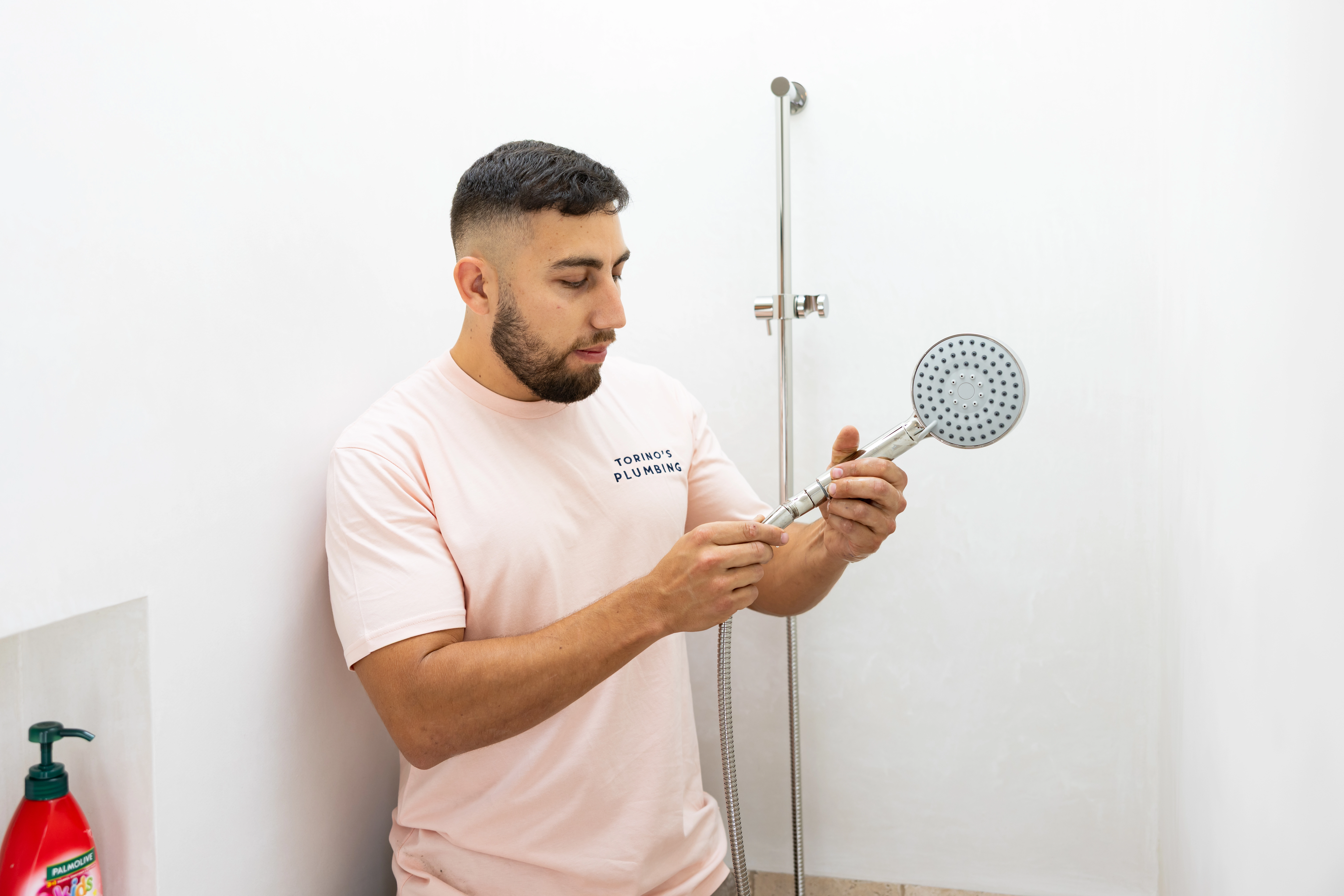 Plumber inspecting a shower fixture