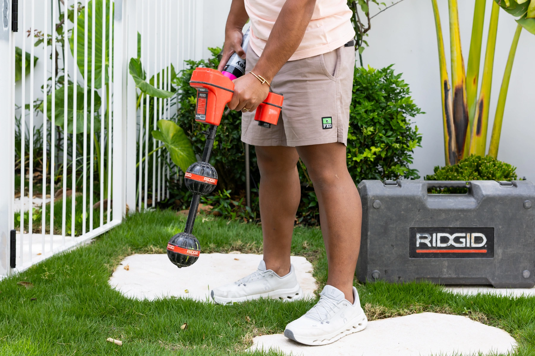 Torino's Plumbing - Guy Plumber holding a drillimg equipment with a Rigid tool box