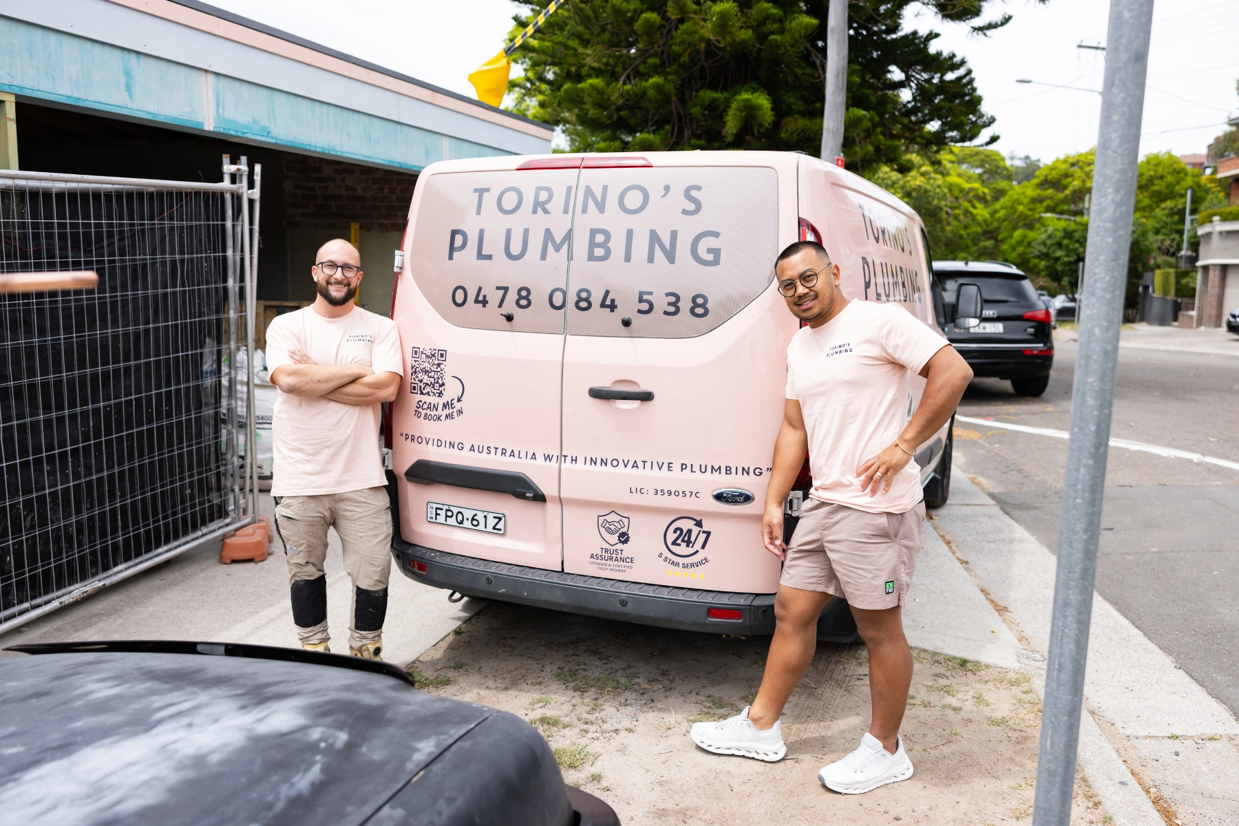 Two Guy Plumbers of Torino's Plumbing standing on their service van